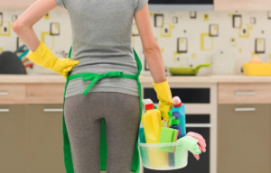 Maid service lady about to clean kitchen
